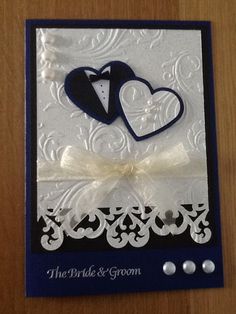 a wedding card with two hearts and a tuxedo on the front in blue