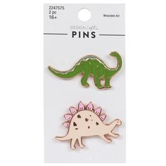 Customize your clothing and accessories with colorful icons that showcase your interests! Dinosaur Enamel Pins are made of rose gold and gold-colored metal and feature a green dinosaur with a long tail and neck and a light pink dinosaur with spikes on its back. Pin them to any fabric item you want to add Jurassic flair to. Dimensions: 	 Length: 7/8" - 1" 	 Width: 1 7/16" - 1 1/2" Package contains 2 pins. Dinosaur Pin, Colorful Icons, Christmas Gift Ideas For Mom, Wearable Art Fashion, Pink Dinosaur, Green Dinosaur, Gift Ideas For Mom, Cool Pins, Long Tail