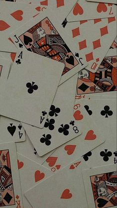 many playing cards are laying on top of each other