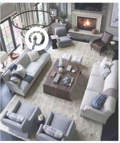 an aerial view of a living room with couches, chairs and a fire place