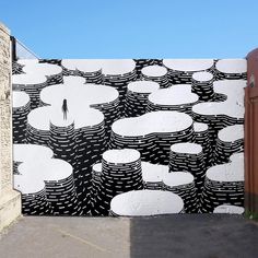 a large black and white mural on the side of a building