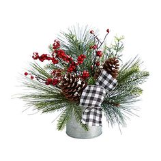 a christmas arrangement with pine cones and berries in a galvanie bucket on a white background