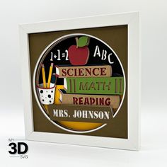 a white frame with some books and pencils in it on top of a table