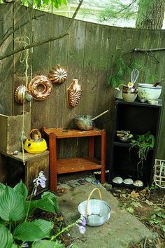 an outdoor area with various pots and plants