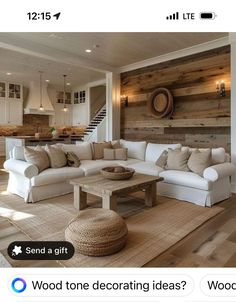 the living room is decorated in white and wood, with an l - shaped couch