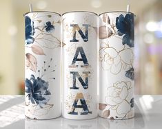 three personalized candles with floral designs on them