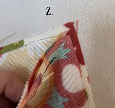 someone is stitching together fabric with scissors