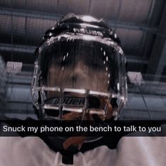 a hockey player wearing a goalie helmet with the words snack my phone on the bench to talk to you