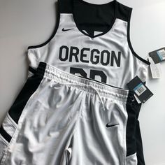 Nike Women Reversible Basketball Jerseys And Matching Shorts. Embroiled Nike Logos Both White And Black Reversible Side. Size M. Oregon. Number 00. Black And White. 100% Polyester. Jersey: Bust 40”. Length 26”. Shorts: Waist 31”-34”. Hip 44”. Length 16”. (Retail Price For The Same Nike Women’s Reversible Basketball Jersey Is $130 And Shorts Is $45) Wife Beater And Basketball Shorts, Nike Logos, Nike Basketball Shorts, Basketball Jerseys, Nike Basketball, Basketball Shorts, Basketball Jersey, Nike Logo, Jersey Shorts