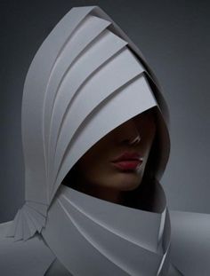 a woman's head is wrapped in white paper with the hood pulled over her face