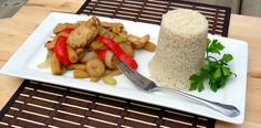 a white plate topped with rice and veggies