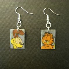 a pair of earrings with cartoon characters on them