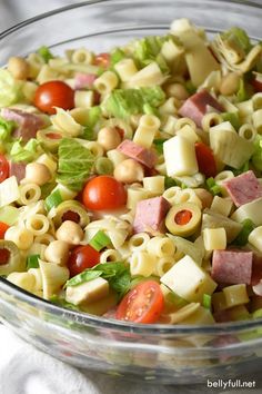 a bowl filled with pasta salad on top of a table