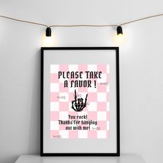 a poster hanging on the wall above a table with lights and a lightbulb