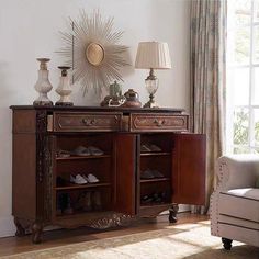 a living room scene with focus on the sideboard and lamp, which is decorated in antique style