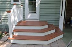 a set of steps leading up to a door on a house's front porch