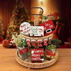 a christmas display with santa's cookies and other holiday decorations on a wooden tray