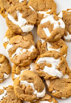 a pile of cookies with white frosting on top