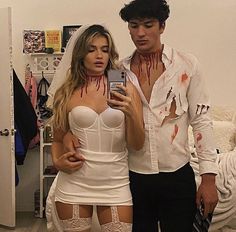 a man and woman dressed up as zombies