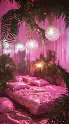 a bed with pink sheets and pillows in a room filled with hanging lights, palm trees and plants