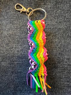 a rainbow colored keychain that has been made to look like a bunch of hair clips