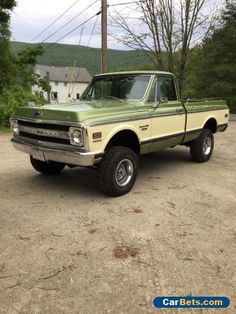 an old pick up truck parked in a lot