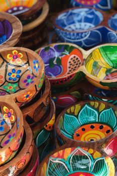 many colorful bowls are stacked on top of each other in the shape of flower petals