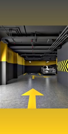 an empty parking garage with yellow arrows painted on the floor and cars parked in it