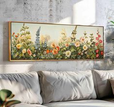 a painting hanging on the wall above a couch