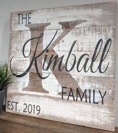 a wooden sign that says the k is for kimball family on top of a table