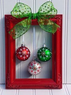 christmas ornaments are hanging in a red frame with green bow on the front and side