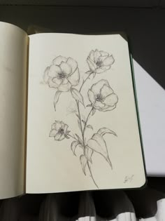 an open book with flowers drawn on it