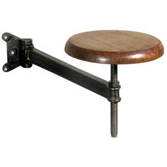 a wooden table with metal legs and a wood seat on it's back end