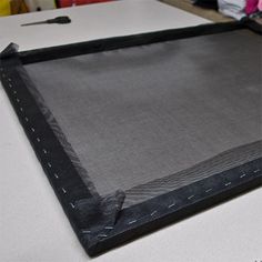 a piece of black fabric sitting on top of a table