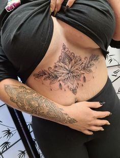 a woman with tattoos on her stomach