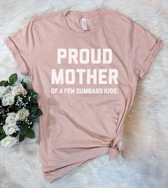 This "Proud Mother Of A Few Dumbass Kids" design is the perfect funny shirt for Mom! Makes a great Birthday Day gift or Mother's Day present! Father's Day Pink T-shirt With Letter Print, Fun Graphic Print Shirt For Mother's Day, Mother's Day Screen Print Crew Neck T-shirt, Pink T-shirt With Funny Text For Gift, Pink T-shirt With Funny Text As Gift, Pink T-shirt With Funny Text As A Gift, Unisex Funny T-shirt With Text, Funny Pink T-shirt With Slogan, Mother's Day Crew Neck T-shirt With Screen Print