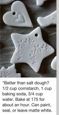 some white cookies are on a table and one has a star ornament in the shape of a snowflake