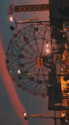 the ferris wheel is lit up at night