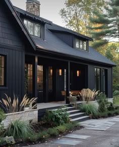 a black house with steps leading up to the front door