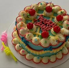 a decorated birthday cake with cherries on top