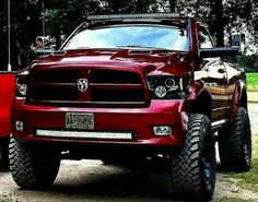 a red ram truck parked on the side of a road