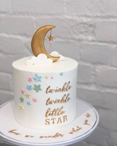 a white cake with gold stars and a crescent on top that says twinkle twinkle little star