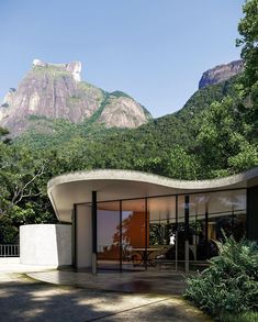 a modern house with mountains in the background