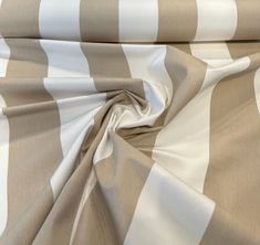 an image of a striped fabric with white and brown stripes on it's surface