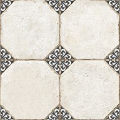 a white and black tile floor with an ornate design