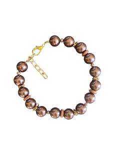 This exquisite chocolate pearl like beaded necklace is a statement piece. Featuring rich brown beads with a radiant luster, it's adorned with gold-toned accents that add an elegant and timeless charm. The adjustable chain ensures versatility and comfort, allowing you to wear it at your desired length. Handmade with attention to detail, this necklace is perfect for special occasions or to elevate your everyday look. Whether you're treating yourself or searching for a thoughtful gift, this piece w Brown Pearls Jewelry, Chocolate Pearls, Beaded Jewelry Necklaces, Brown Necklace, Necklace Elegant, Necklace Gold, Gold Accents, Everyday Look, Statement Pieces