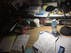 a cluttered desk with several papers on it