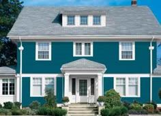 a blue two story house with white trim