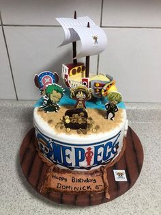 a birthday cake decorated to look like a pirate ship with characters on the front and sides