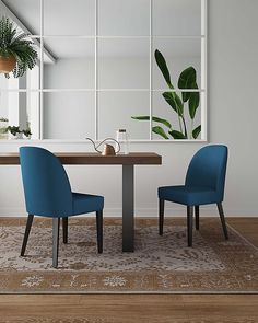 two blue chairs sitting at a wooden table